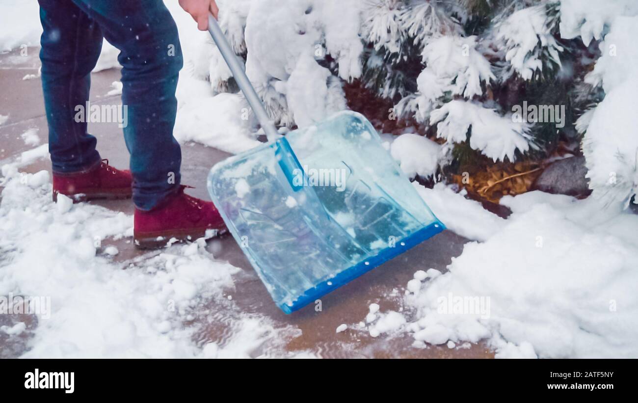 Young man shoveling snow from driveway Stock Photo Alamy
