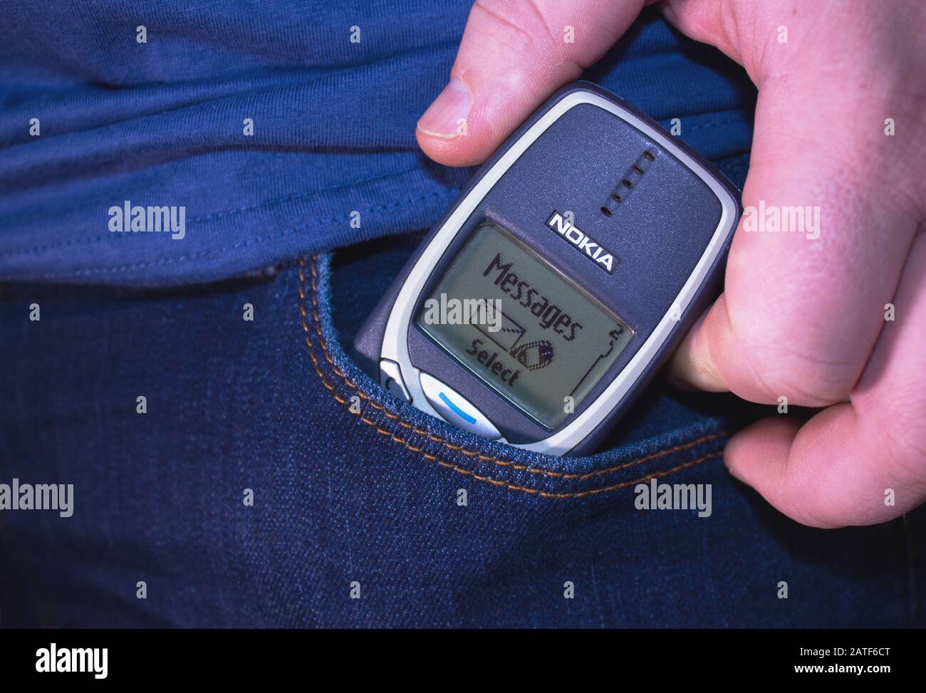 Petrozavodsk. Karelia. Russia. January 8. 2020: Man's hand takes an old Nokia cell phone with a message on the screen out of blue jeans pocket Stock Photo