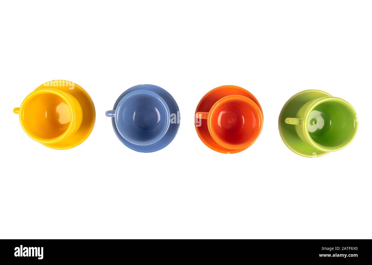 Four different colour empty coffee ceramic cups or tea cup isolated on white with clipping path. Empty space for text. Stock Photo