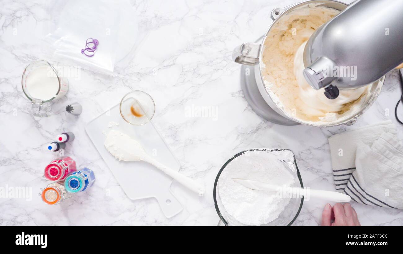 Mixing ingredients in standing kitchen mixer to make buttercream