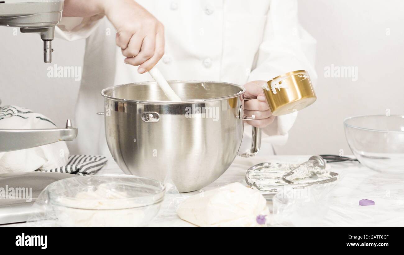 Mixing ingredients in standing kitchen mixer to make buttercream