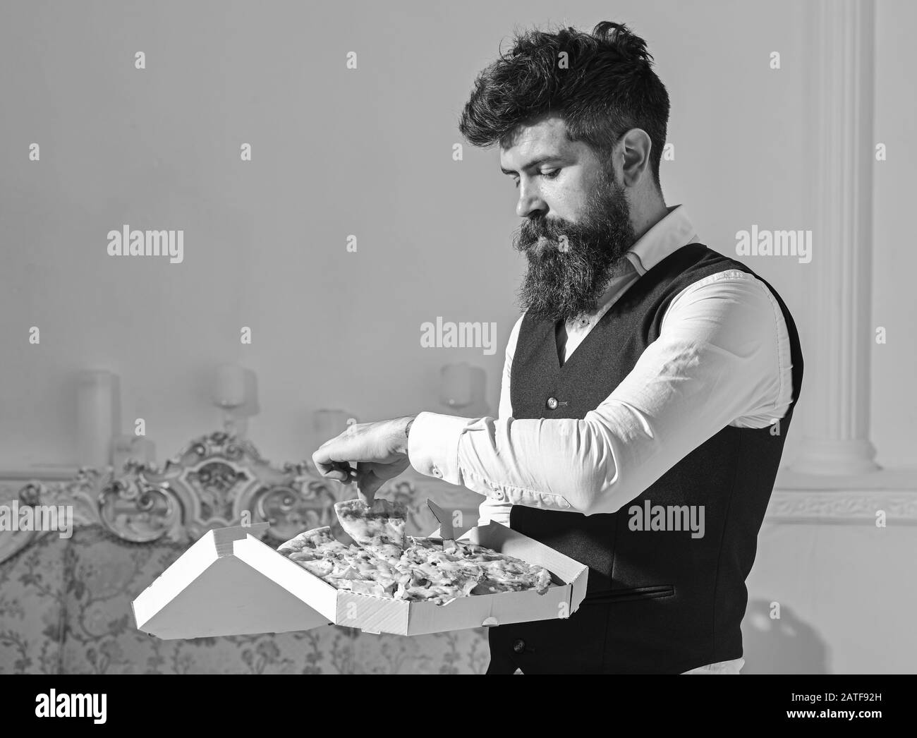 Man with beard and mustache holds delivered box with tasty fresh hot