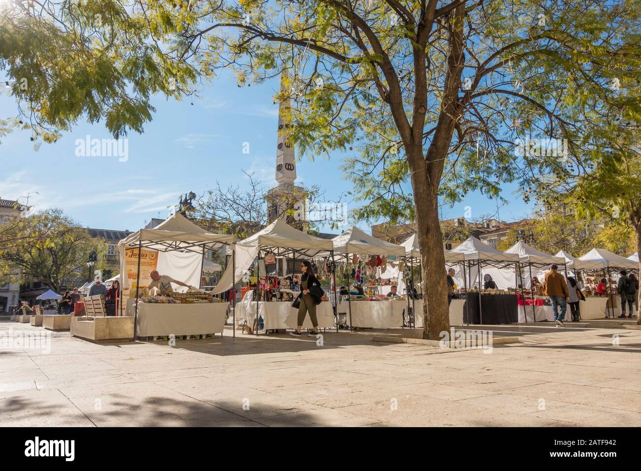 Malaga Spain. Local market stalls at Plaza de la Merced (Mercy Square) with the Monument to Torrijos, public square, Malaga, Andalucia, Spain. Stock Photo