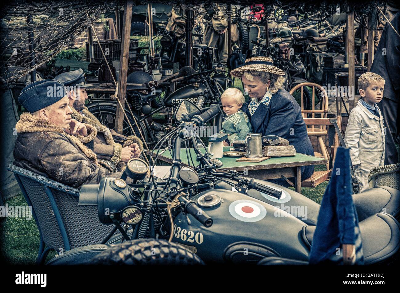 A family having a grand day out at the Goodwood Revival dressed in clothes appropriate to the second world war Stock Photo