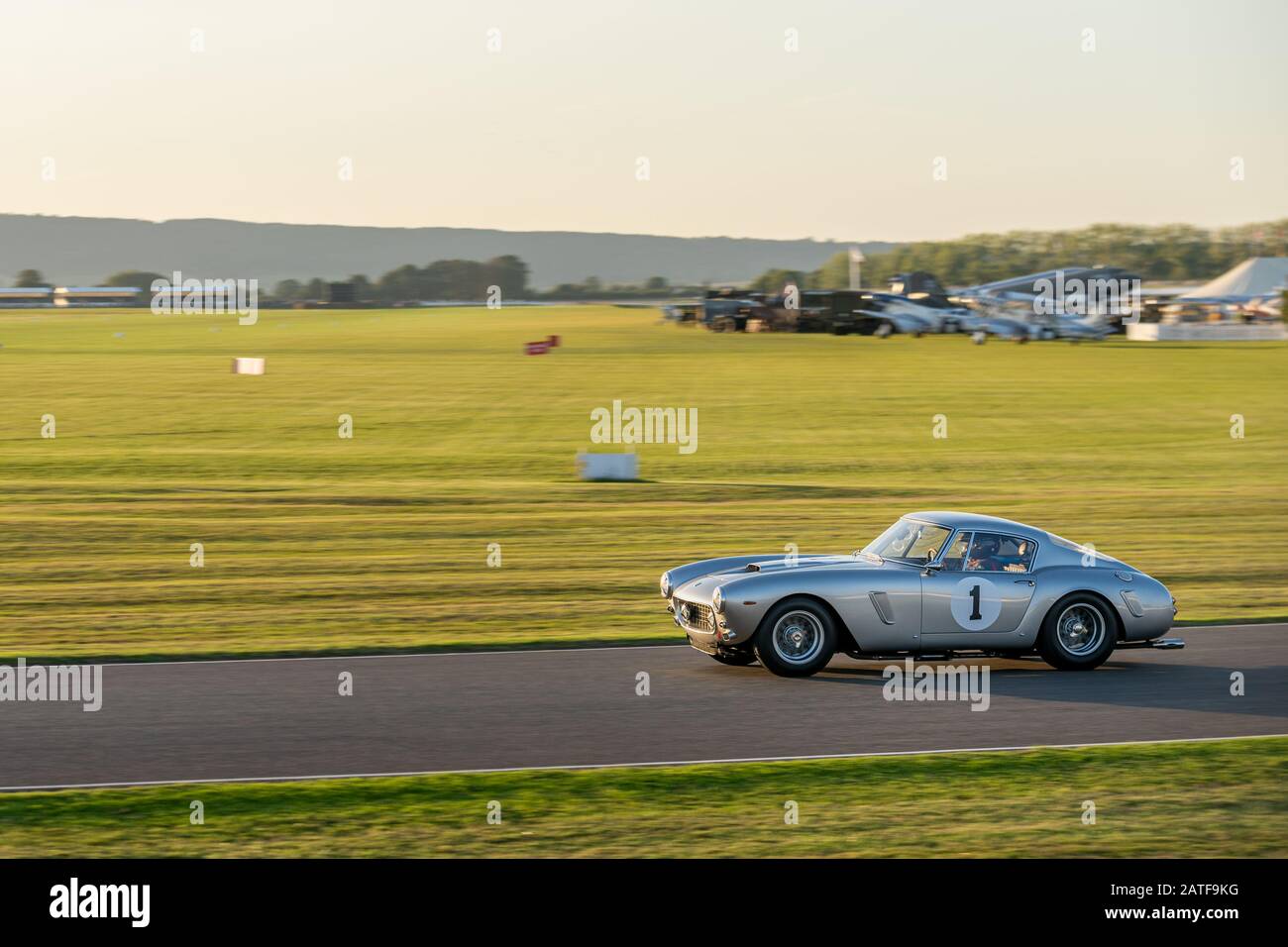 Goodwood Revival and a  Ferrari 250 GT swb Berlinetta hurtling round the Goodwood Motor circuit during the Kinrara Trophy Race. Stock Photo