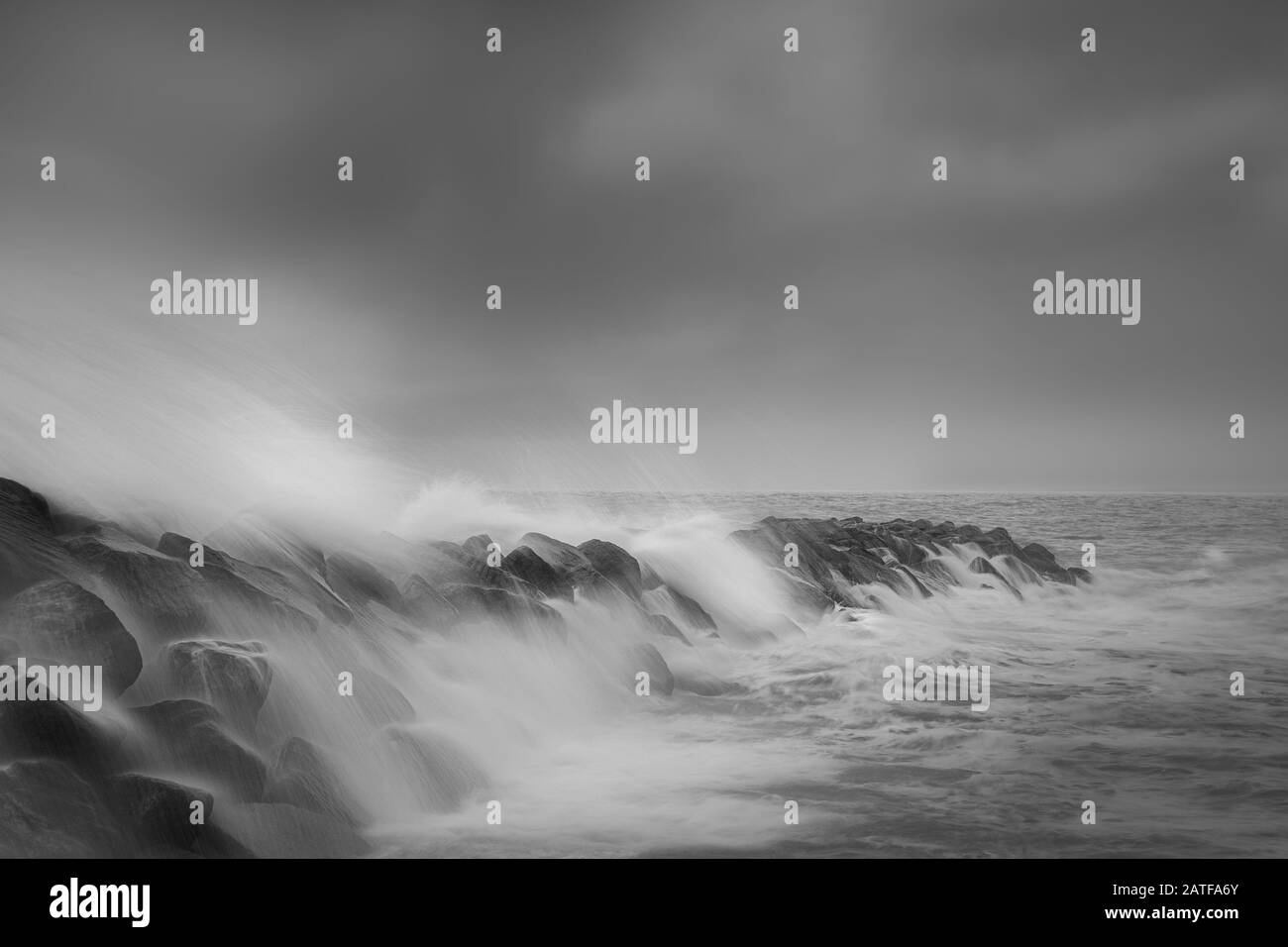 Salty Sea spray surging over the breakwater at Selsey Stock Photo