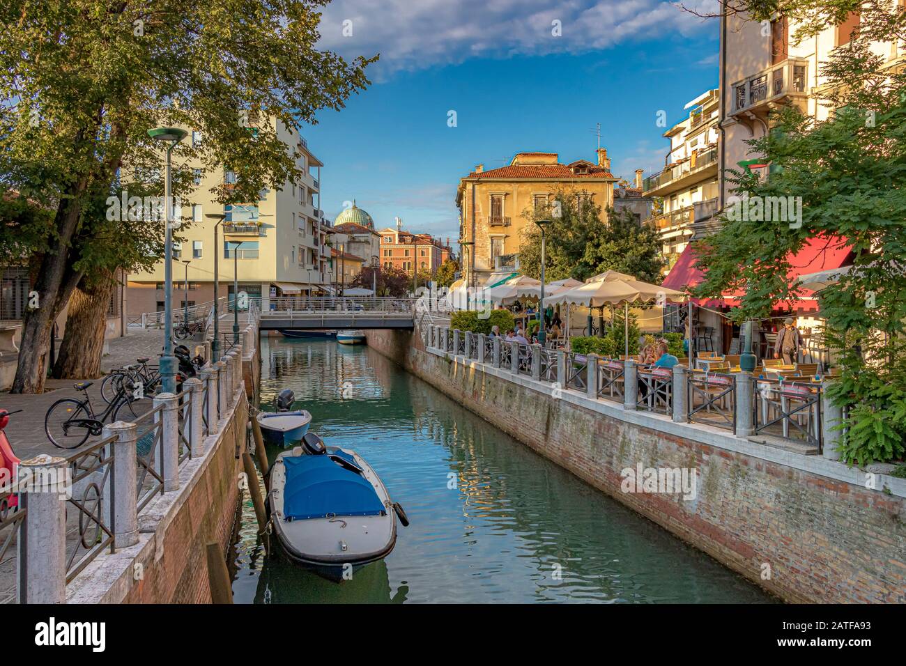 People at a restaurant along side the canal on Via Vettor Pisani ,Lido ,Venice ,Italy Stock Photo
