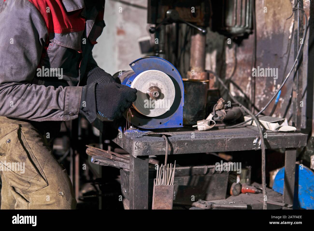 tool sharpening manually on an power grinding wheel Stock Photo