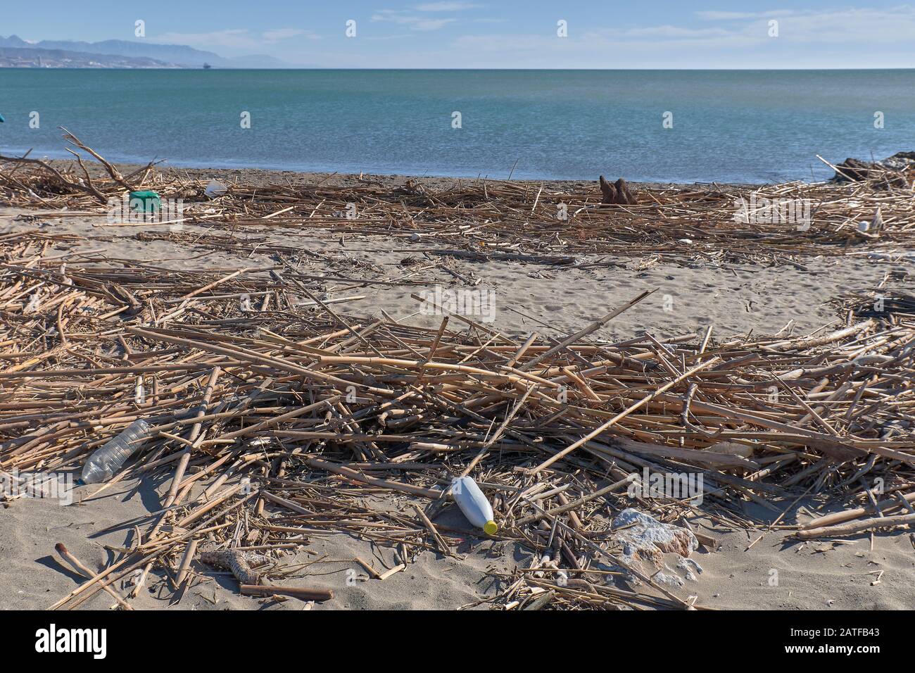 Spilled garbage on the beach of the big city. Empty used dirty plastic bottles. Dirty sea sandy shore the Black Sea. Environmental pollution. Ecologic Stock Photo