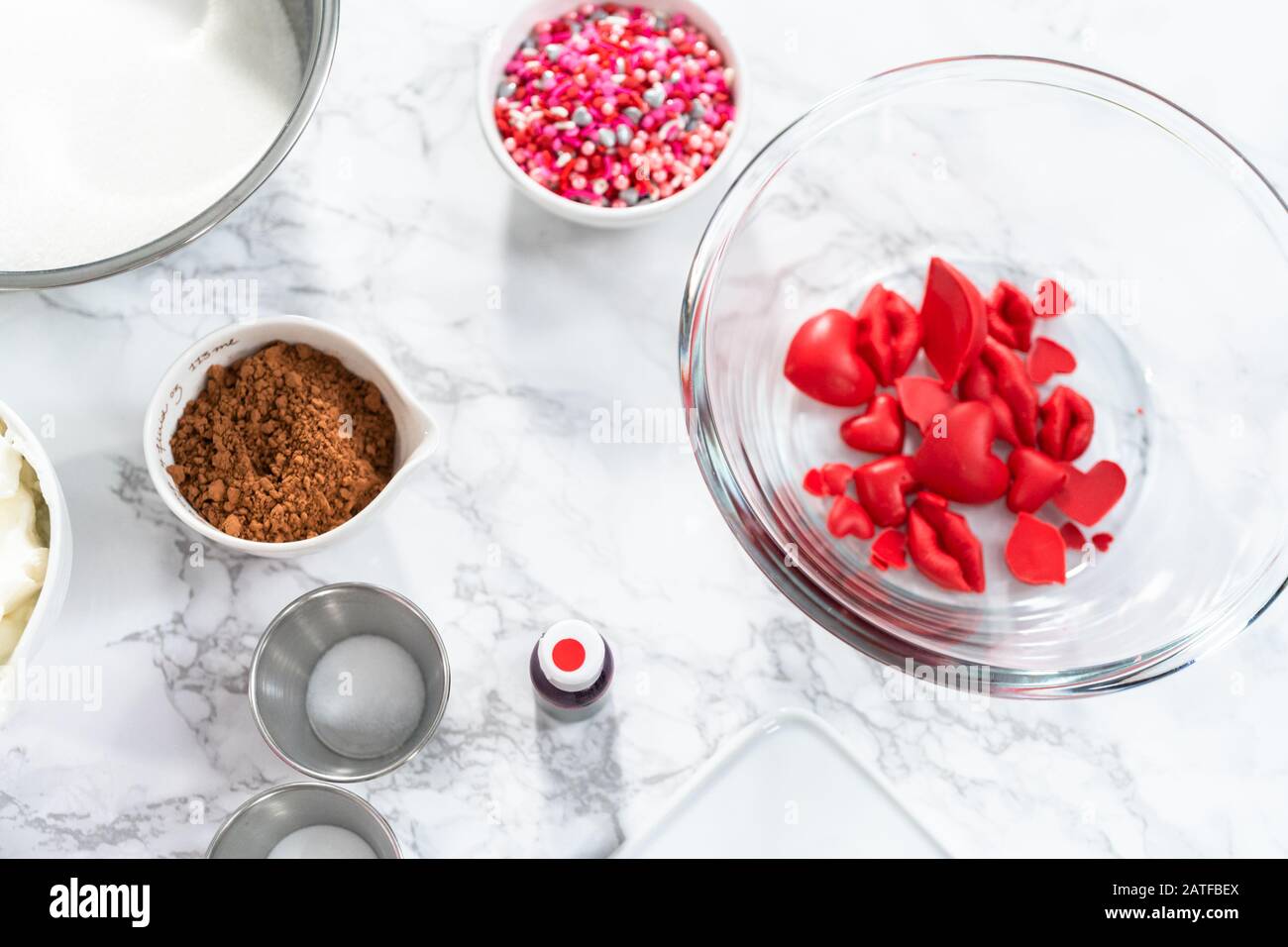 Making hear and kiss shaped chocolate molds with red candy melts Stock