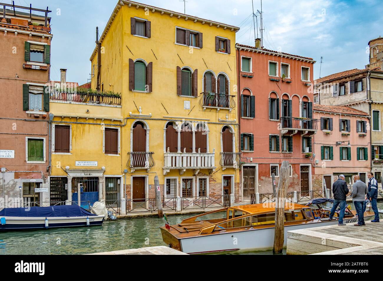 Beautiful old building along the rio de santa fosca canal ,as people board a water taxi in The Cannaregio district, Venice ,Italy Stock Photo