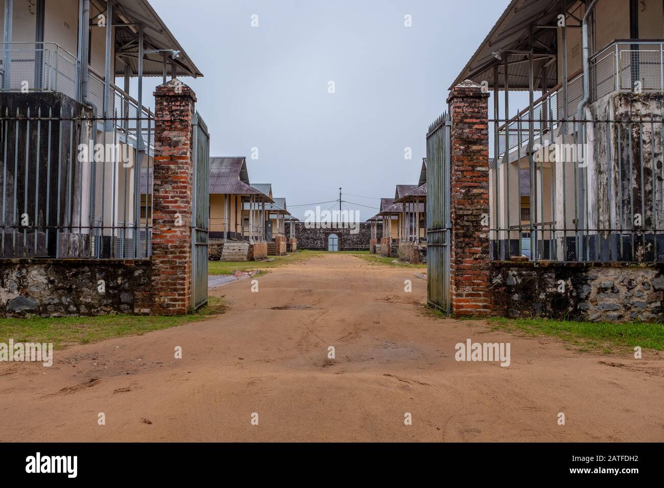 Central perspective on the entrance of the prison of St-Laurent-du-Maroni, taken on an overcast day with no people, French Guiana. Stock Photo