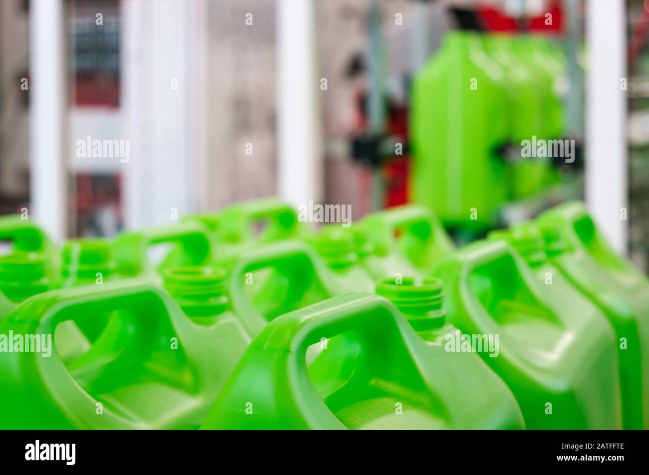 A many green plastic cans canister on a pallet, production of plastic products PVC extrusion method Stock Photo