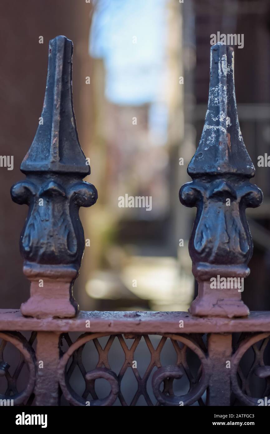 Detailed iron work ornament atop a gate, Harlem, New York, NY, USA