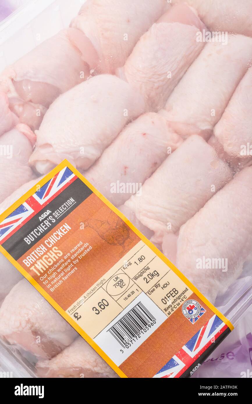 Plastic film wrapped ASDA chicken thighs with Union Jack graphic - British farm produce concept, food label close up, UK meat products. Stock Photo