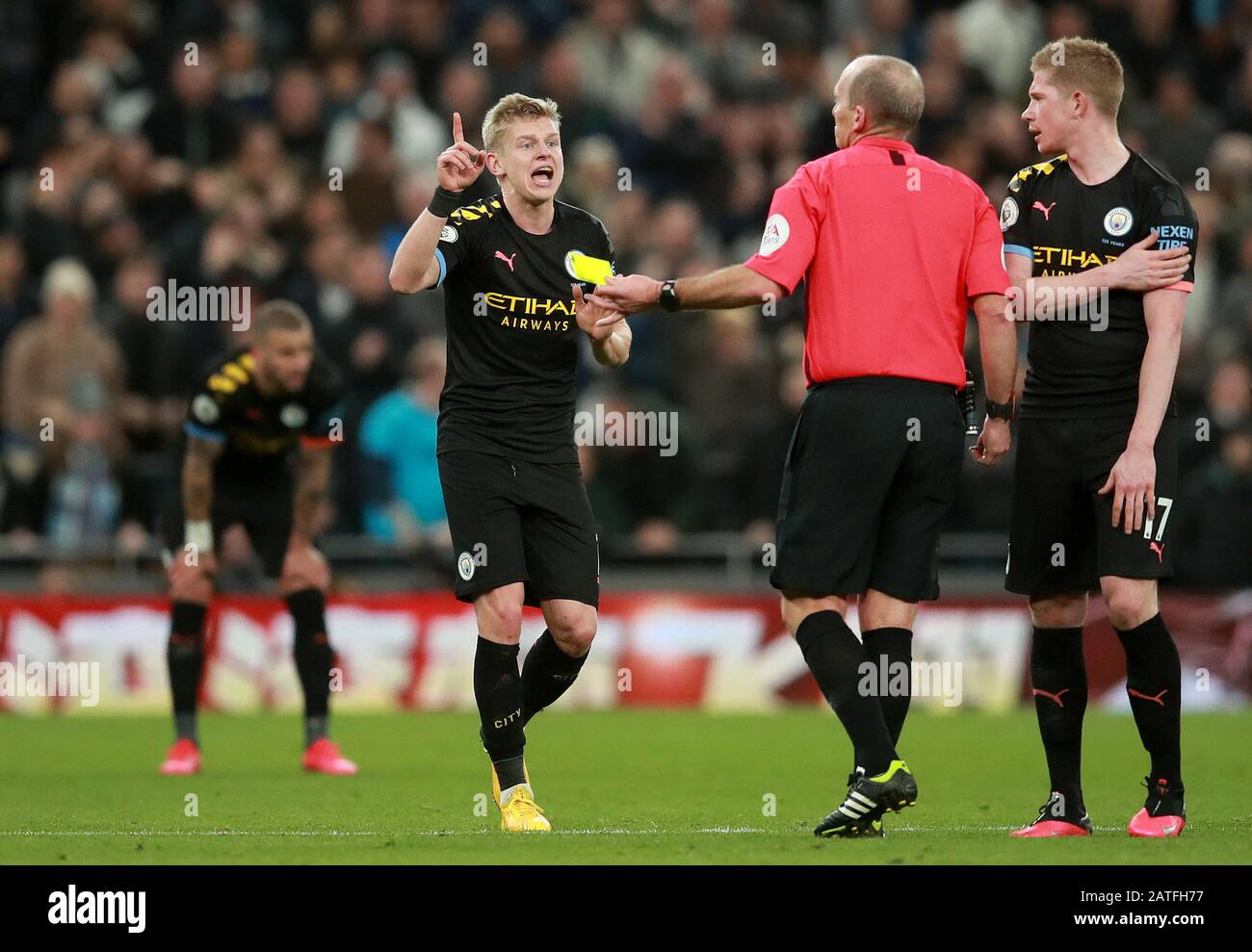 Manchester City's Oleksandr Zinchenko (left) is shown a second yellow