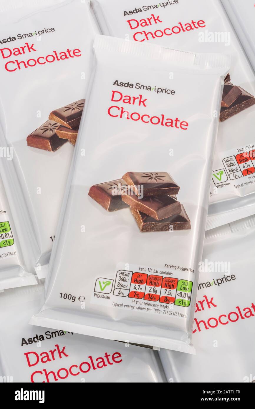 ASDA dark chocolate soft plastic food packaging dietary nutrition information box, food fat content, sugar content, food label close up, high in sugar Stock Photo
