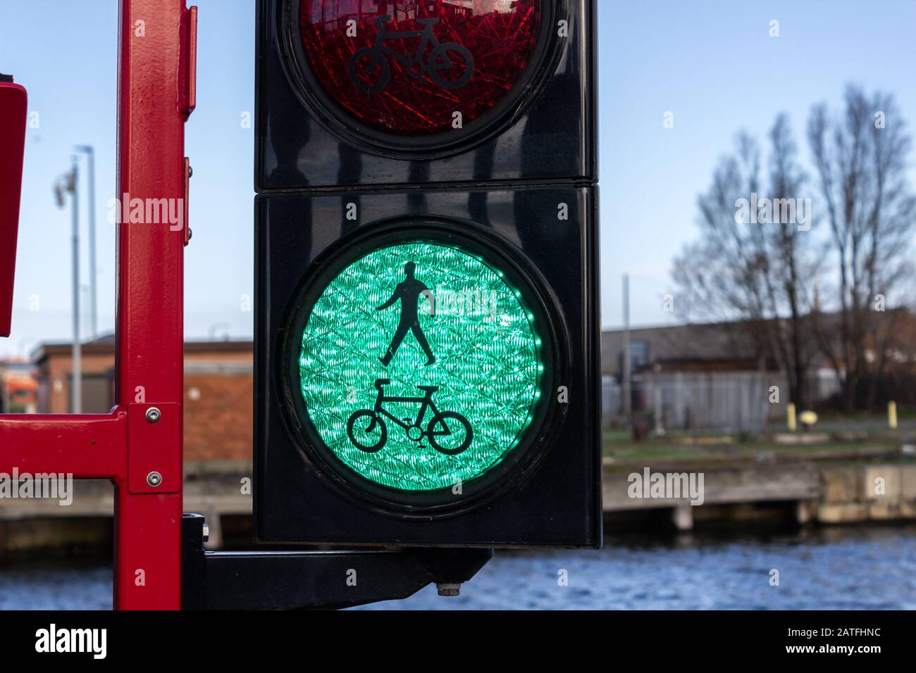 Green pedestrian and cyclist traffic light on bascule bridge, Four Bridges, Birkenhead Stock Photo