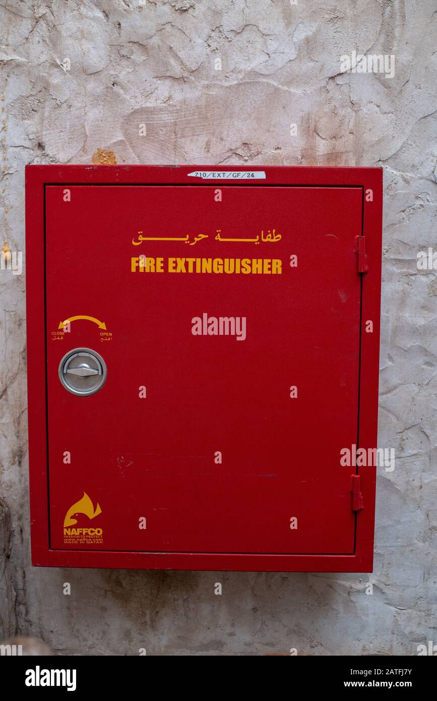 A red fire extinguisher box, set on a white wall, ensures safety and protection from danger Stock Photo