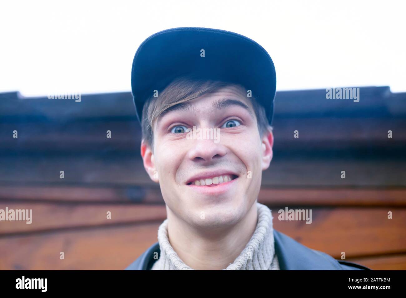 Portrait of a young happy guy 20-21 years old in a cap. Stock Photo