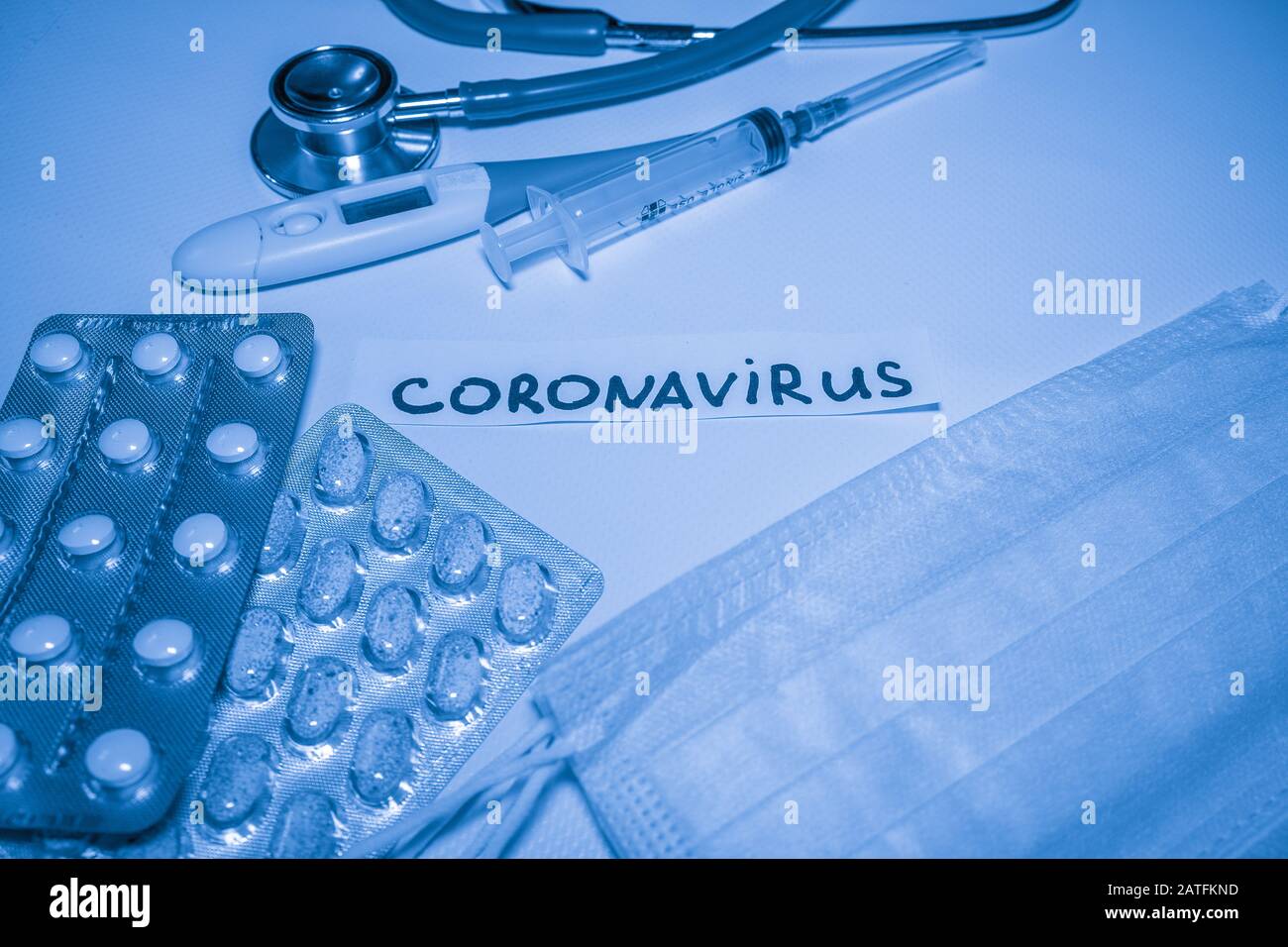 Novel coronavirus-2019-nCoV. Medical blue background with inscription coronavirus, stethoscope, pills, thermometer, syringe. Stock Photo