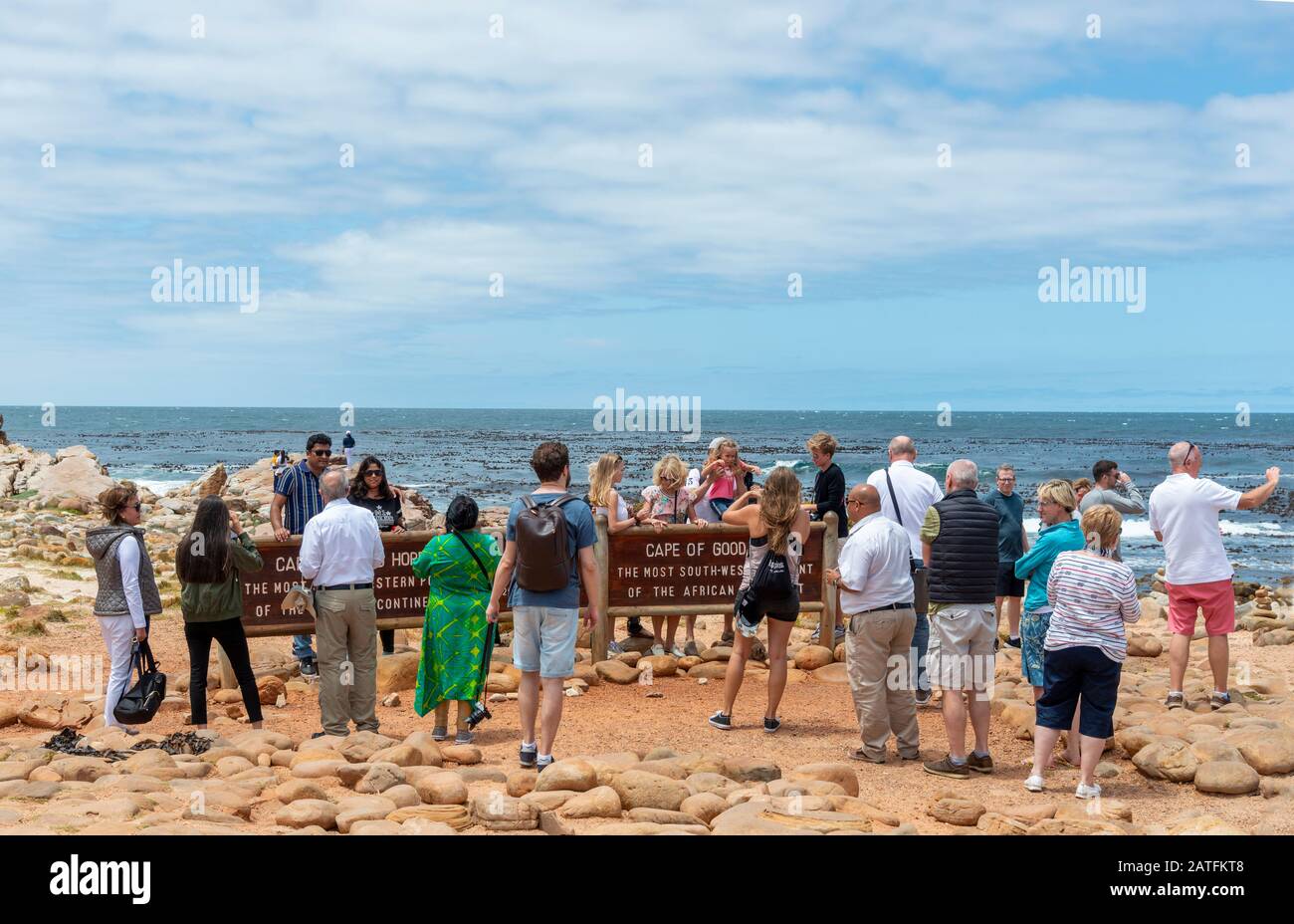Crowd of visitors stand around the Cape of Good Hope sign in the Cape Point National Park, South Africa Stock Photo