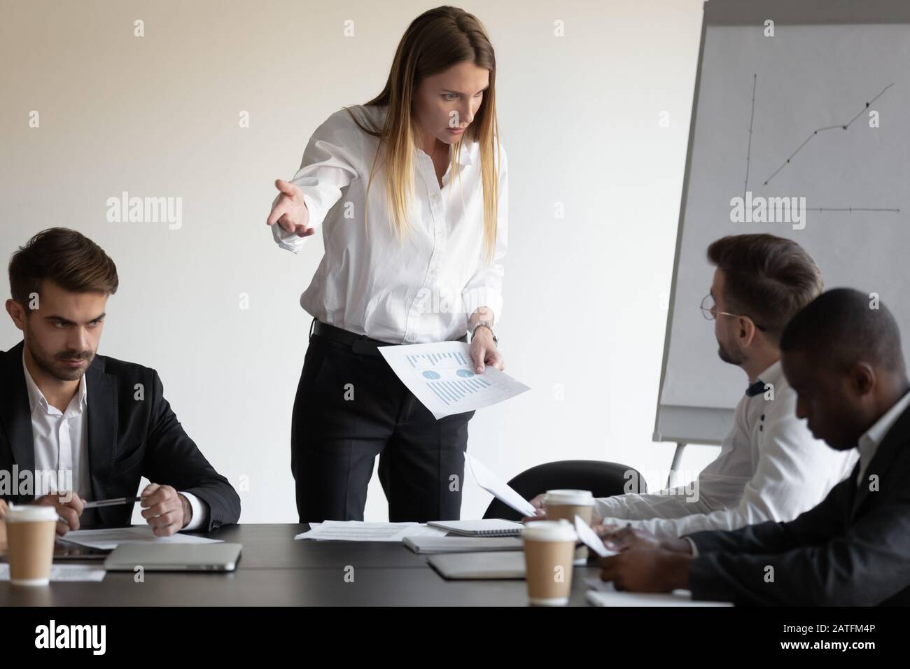 Female boss and employee having conflict during meeting in boardroom Stock Photo