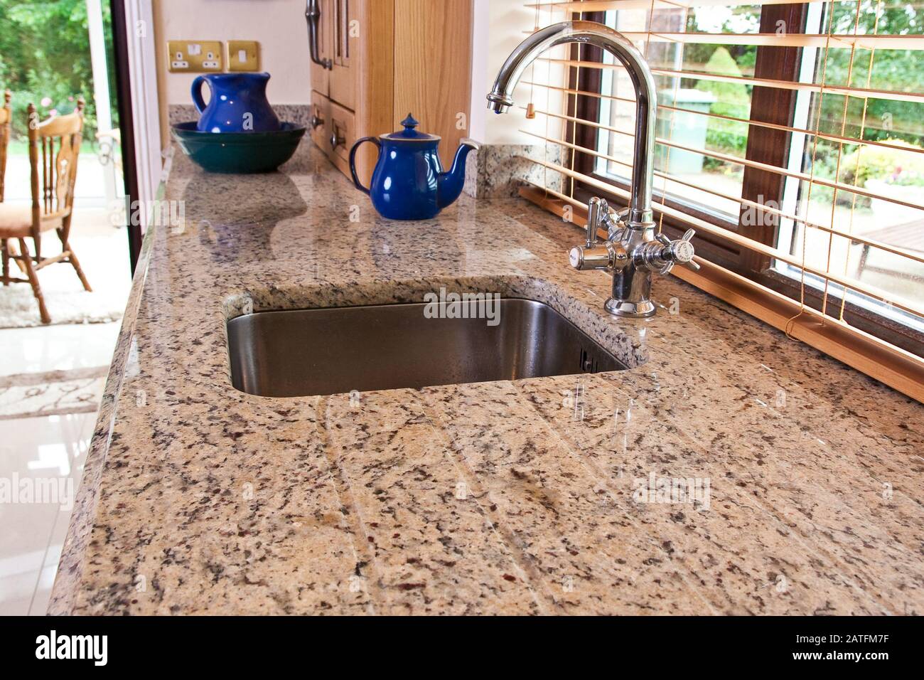 cottage style kitchen in wooden finish and granite worktop Stock Photo