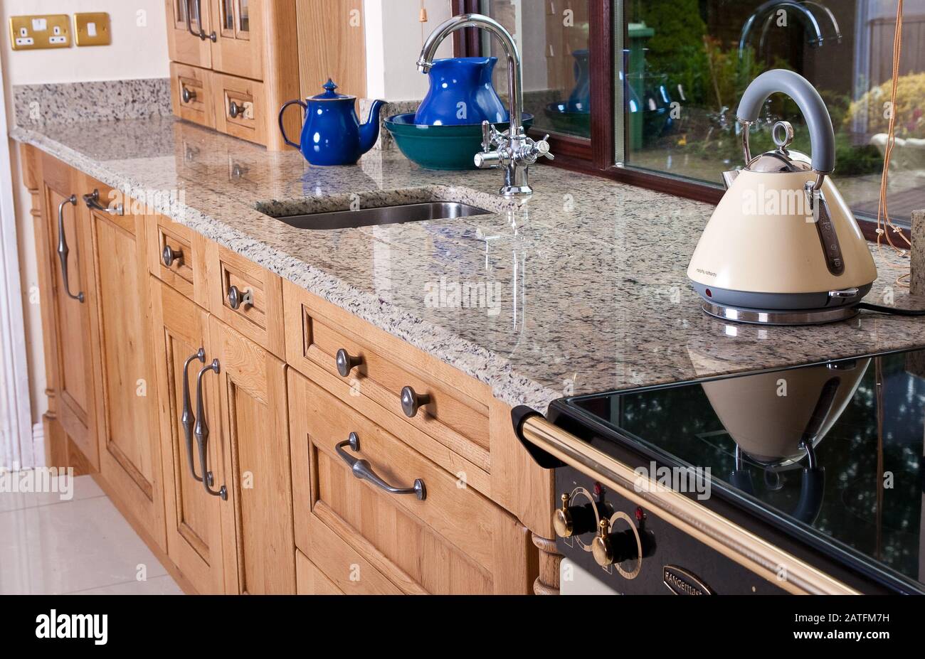 cottage style kitchen in wooden finish and granite worktop Stock Photo