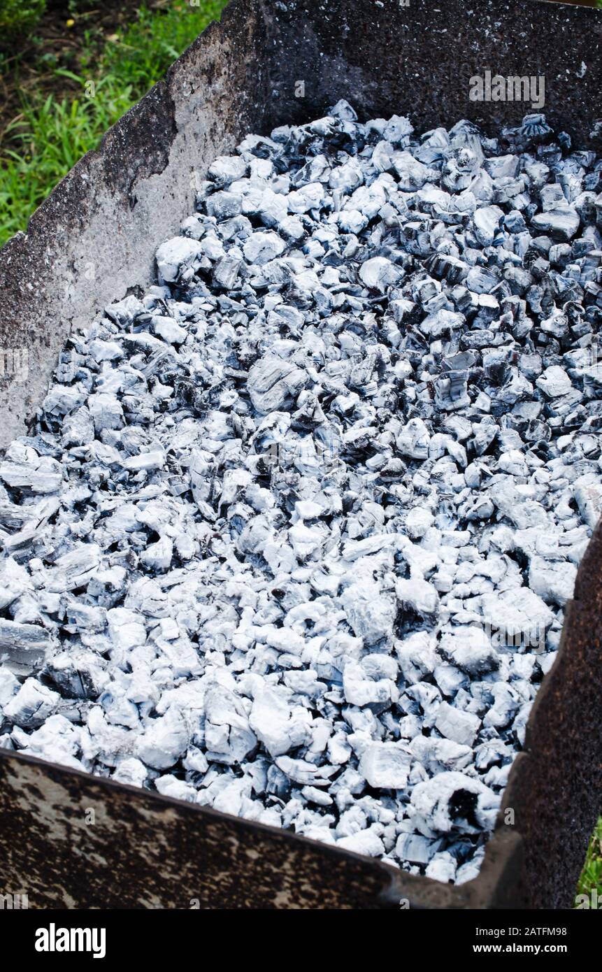 Gray burnt coals in a barbecue. Bonfire for a picnic. Summer, hot