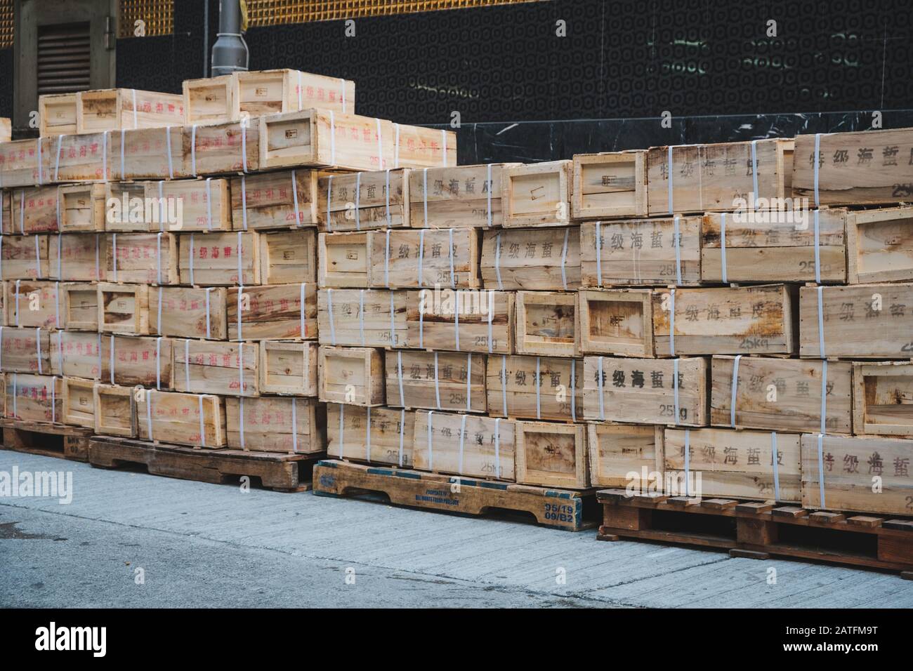 Hongkong, Hong Kong - November, 2019:  Chinese import, export goods in wooden boxes stacked on pallet Stock Photo