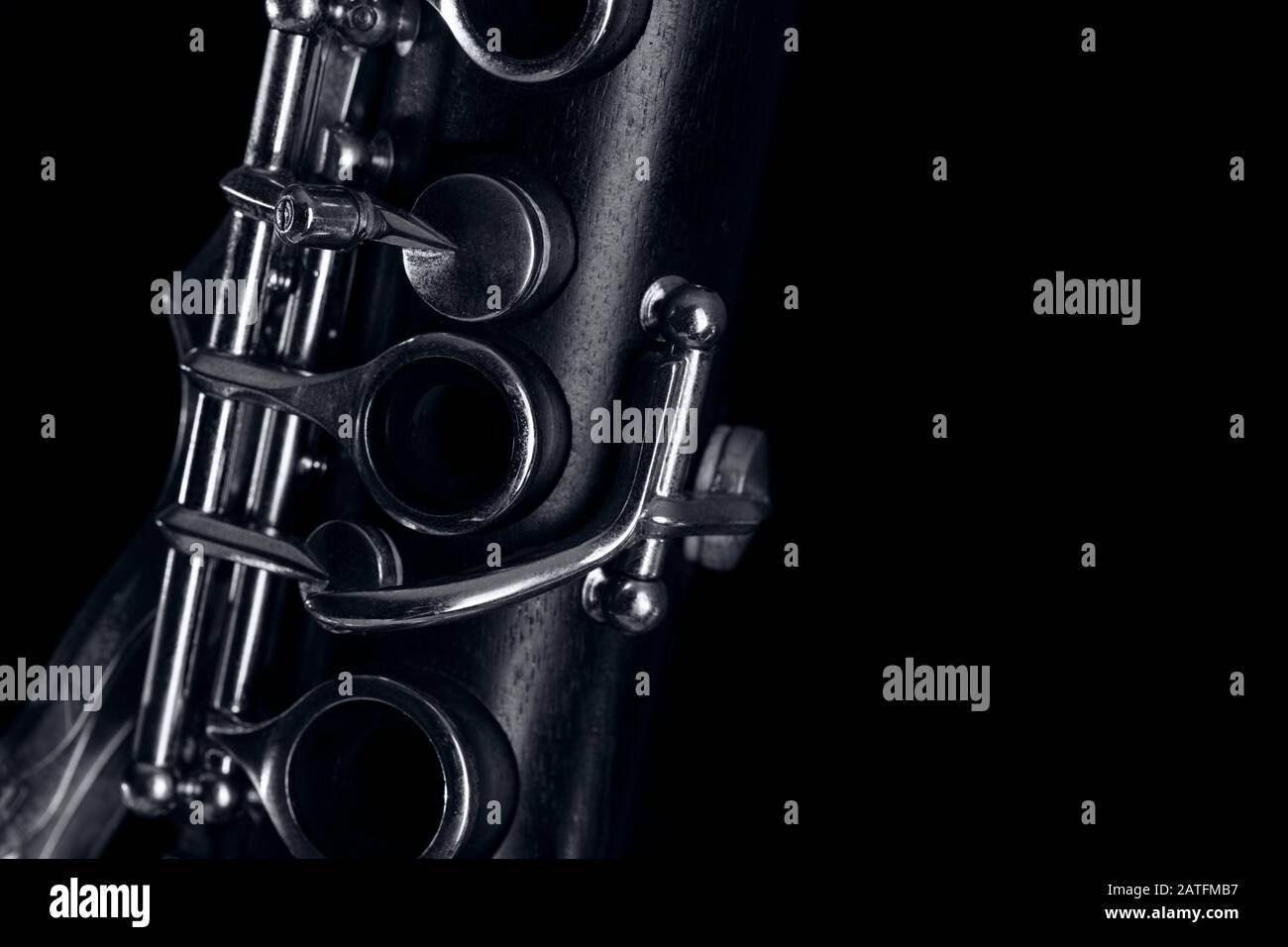 part of the clarinet body, with the silver mechanisms on the wood. Black background and free space for text Stock Photo