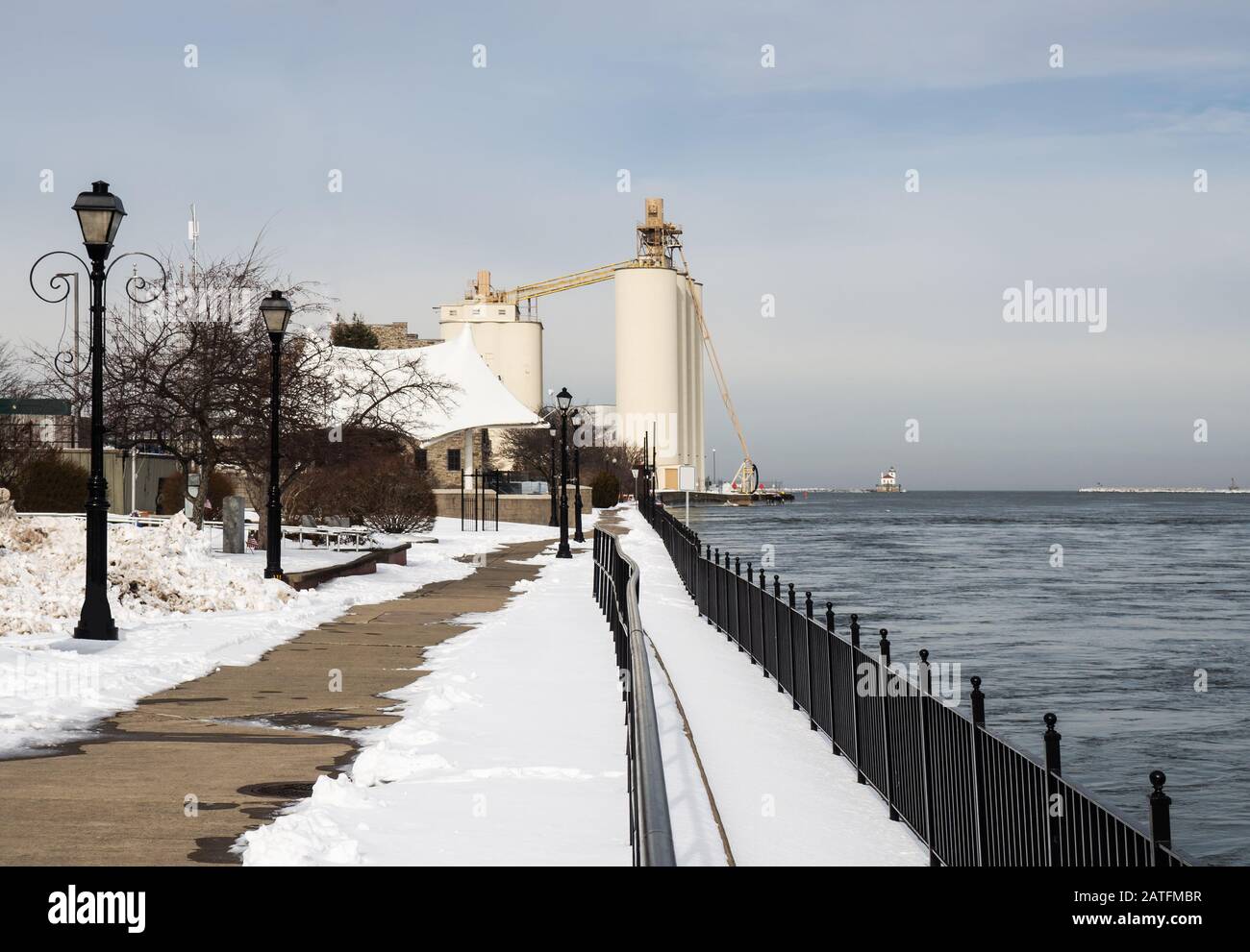 Oswego, New York, USA. January 23, 2020. View of a public walkway facing the Port of Oswego and lake Ontario in Oswego, New York on a winter afternoon Stock Photo