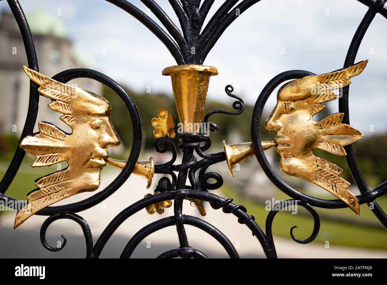 Ornament forged iron garden gate. Gold and black Stock Photo