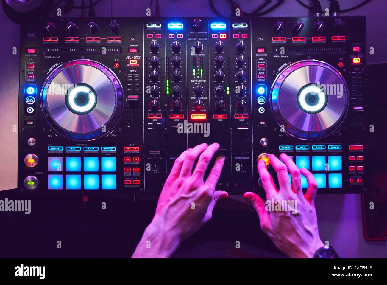 Dj mixes the track in the at a party Stock Photo Alamy