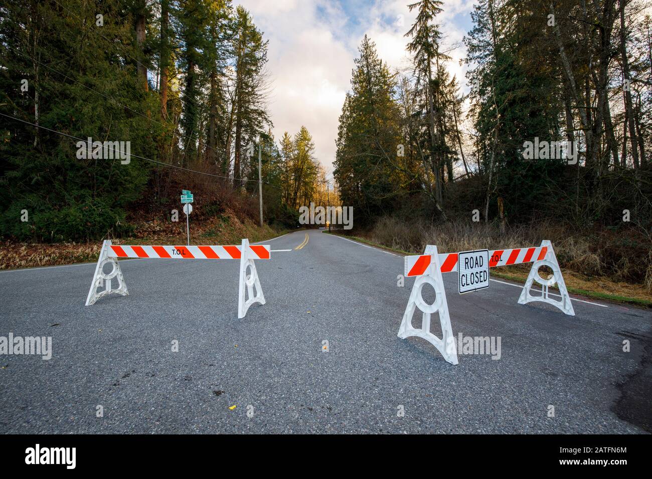 Road closed by barriers blocking access Stock Photo