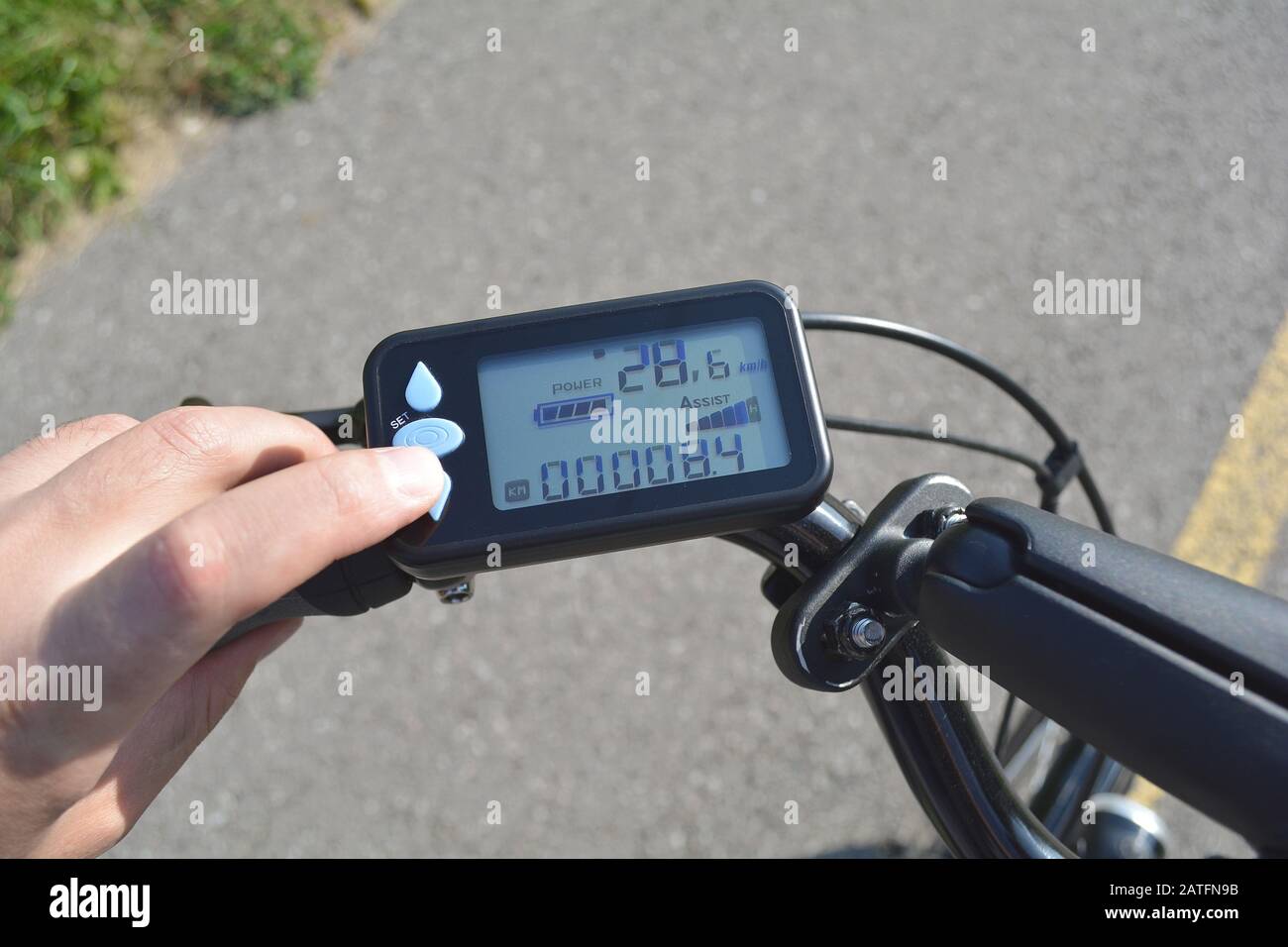 Man turning on electric bike or ebike. On board display with modern
