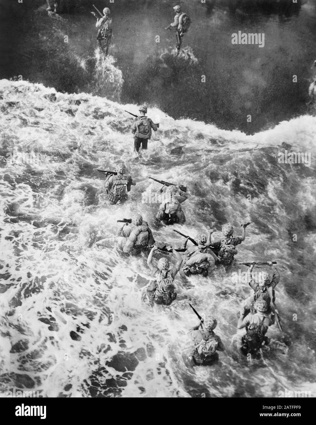 U.S. Marines hit three feet of water as they leave their LST to take the Beach at Cape Gloucester, Papua New Guinea, U.S. Department of Defense, U.S. Marine Corps photo, December 26, 1943 Stock Photo
