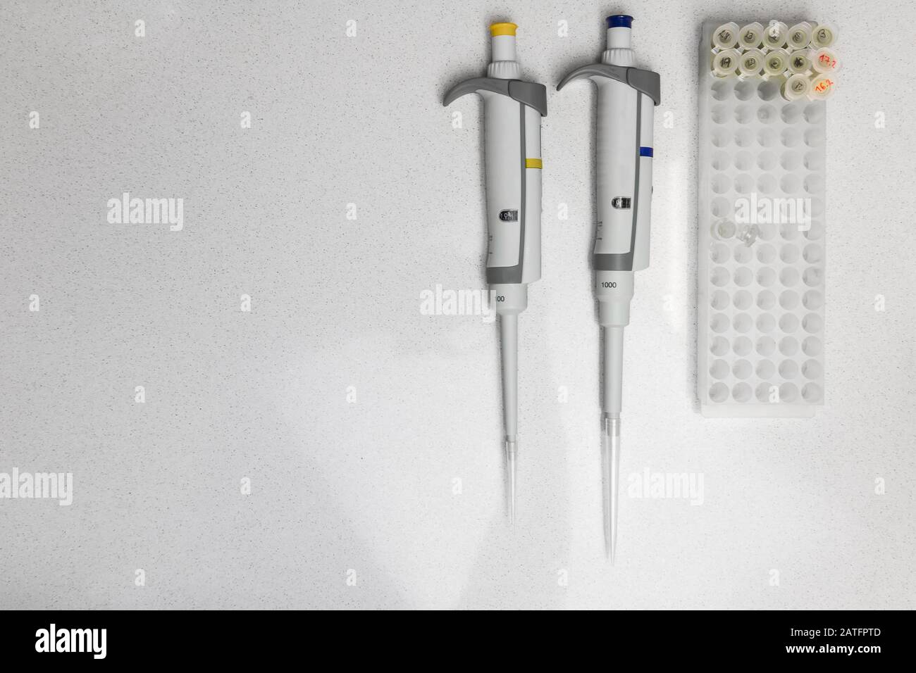 Chemical equipment are on the white background. Automatic pipettes and ...