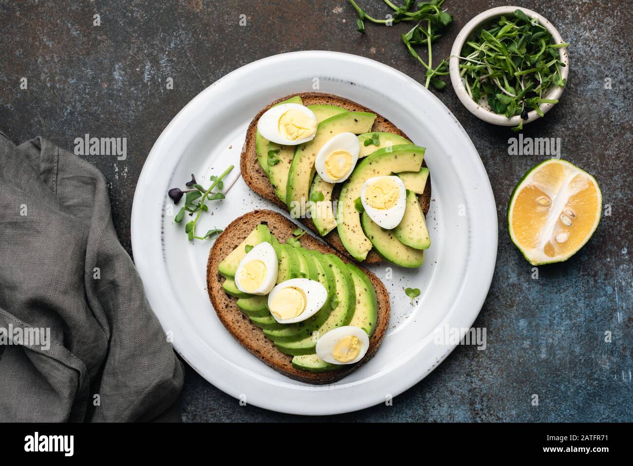Rye bread toast with avocado and quail egg. Top view. Healthy breakfast
