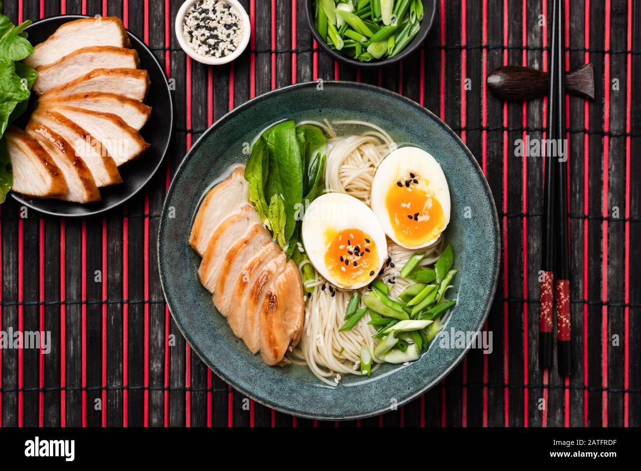 Asian Noodle Soup Ramen With Chicken And Egg Served In Bowl On Bamboo Mat. Top View Stock Photo