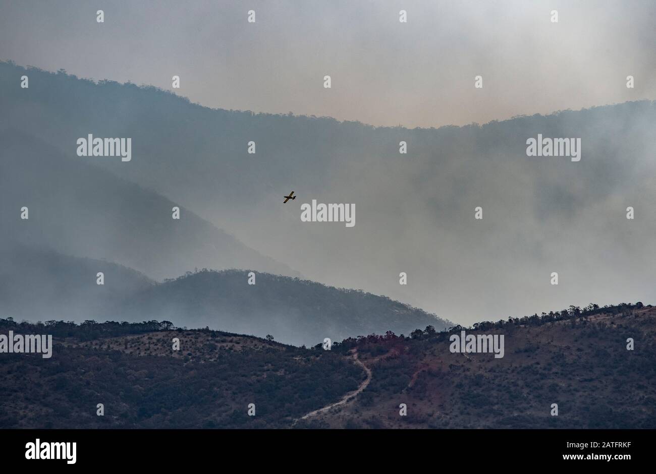 Orroral Valley Bushfire, Canberra, Australia, 02 Feb. 2020. Image taken of fire retardant operations in the hills near Banks, Canberra, Australia. The fire is threatening the southern suburbs of Canberra, ACT and the retardant drop is to try to control the blaze from reaching populated areas. Credit: FoxTree gfx/Alamy Live News Stock Photo