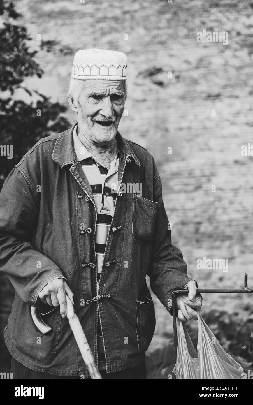 an old man with a shanghai ( marine clothing ) and a beautiful smile on his face Stock Photo