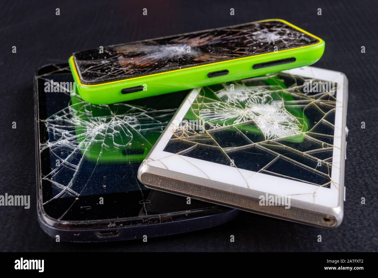 Broken smartphone screen. Broken cell phones. Dark background. Stock Photo