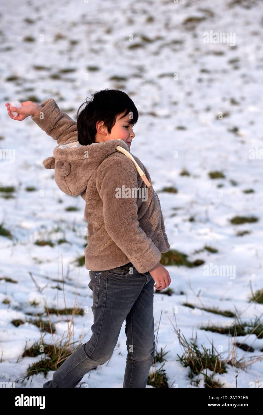 Child throwing a snowball Stock Photo