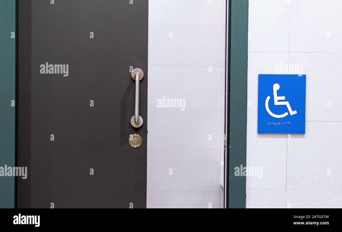 Clean and modern bathroom for disabled people with the sign of person