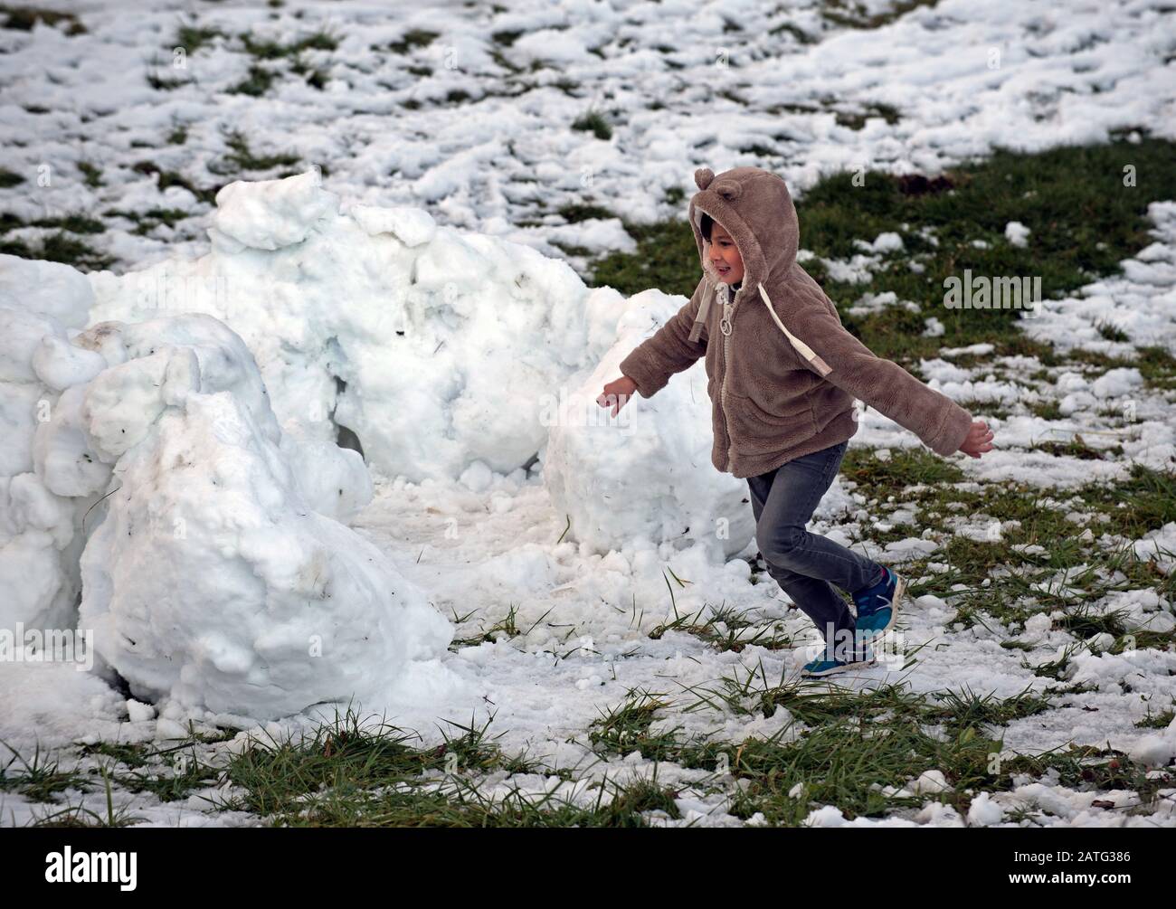 Boy running in the snow Stock Photo