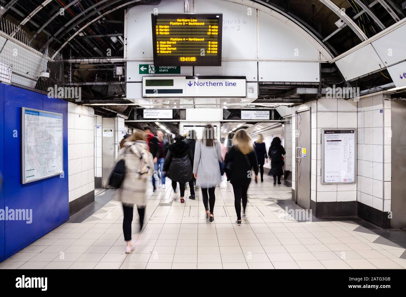 Passengers hurry down a corridor at Bank London Underground station to platforms on The Northern Line. Stock Photo