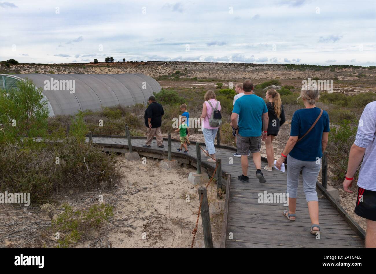 Visitors walking to the covered area to view prehistoric fossils at the West Coast Fossil Park, Langebaanweg, Western Cape, South Africa Stock Photo