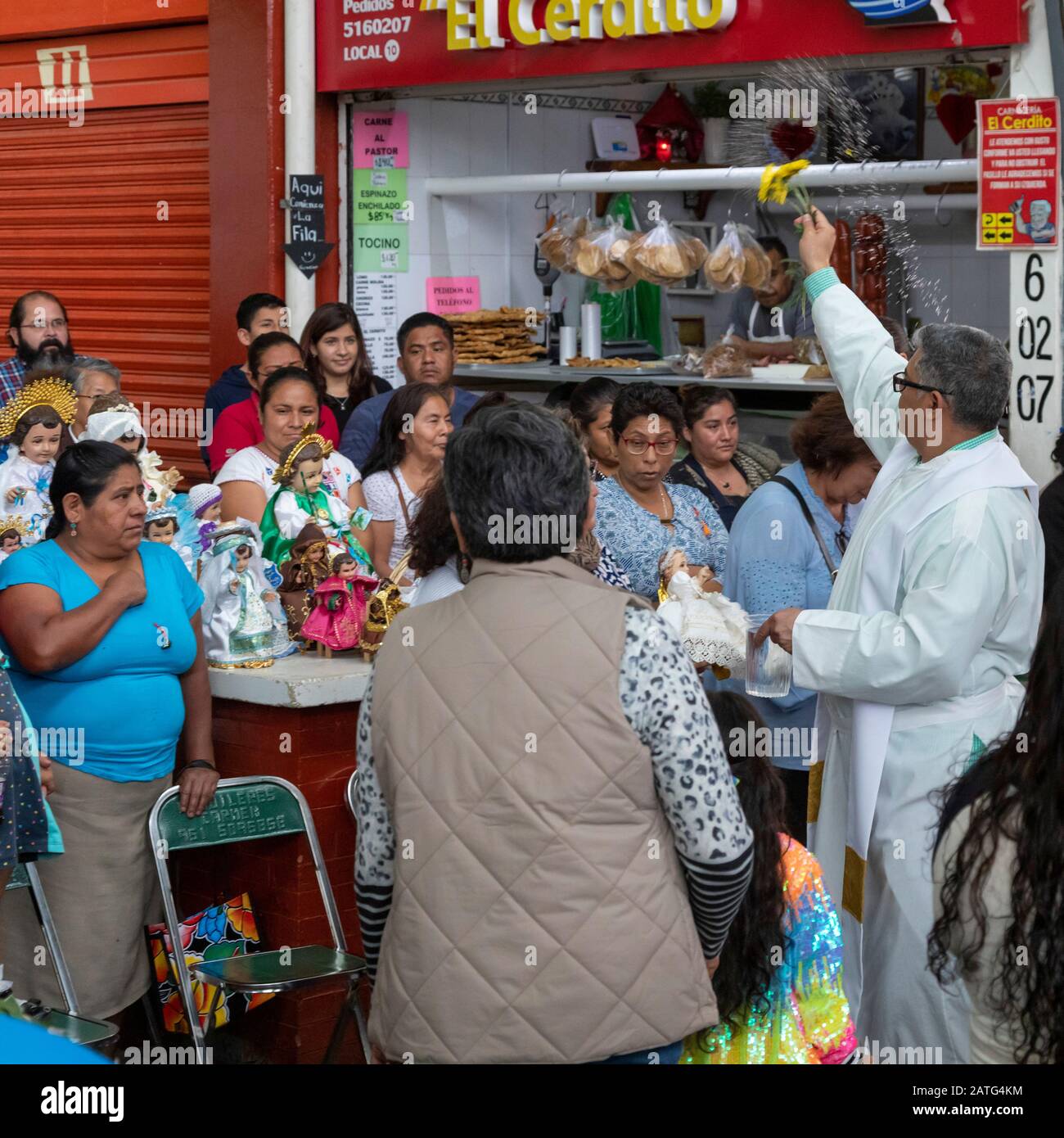 Oaxaca de Juarez, Mexico. 2nd Feb, 2020. Fr. Hector Zavala Balboa celebrates mass at the Sanchez Pascuas neighborhood market on the Dia de la Candelaria, celebrating 40 days after the birth of Jesus. Families dress up dolls of the Baby Jesus and take them to mass to be blessed. Credit: Jim West/Alamy Live News Stock Photo